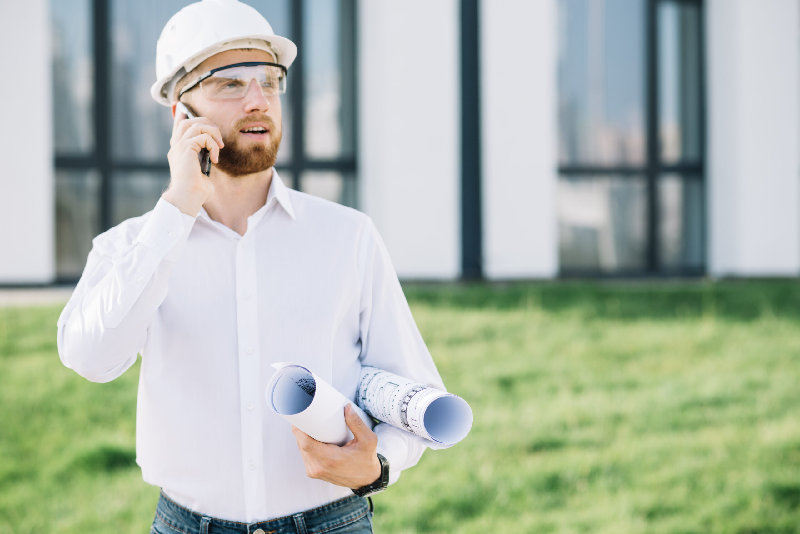 Home man with blueprints talking phone